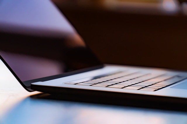 Close-up view of a laptop keyboard illuminated by soft light, emphasizing the sleek, modern design websites.